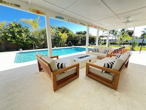 Unwind at this sunny retreat with a heated saltwater pool and stylish outdoor lounge patio — perfect for relaxing, grilling, and soaking up the Florida vibes.