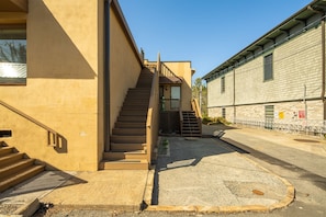 at the top of the stairs, you will see a gate to the left, open it onto private deck