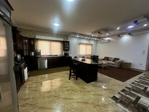 kitchen with island, attached family den with TV and satellite