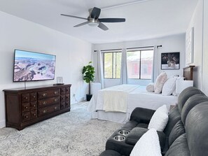 Bedroom with king bed, seating area, smart TV, and spacious closet
