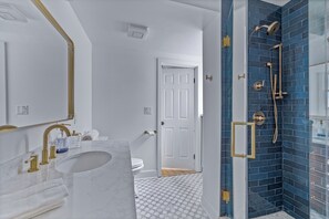 Step into your own private sanctuary, complete with luxe gold accents and a deep blue shower that wows.