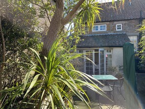 Sunny private garden with table and 4 chairs