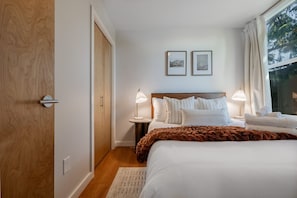 Recharge in this serene space featuring a plush queen bed.
