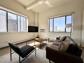 Spacious living room with city skyline views
