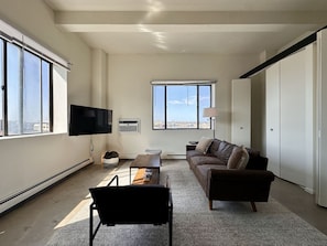 Spacious living room with city skyline views