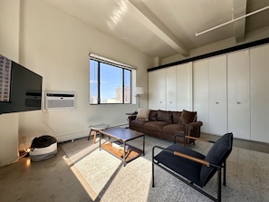 Spacious living room with city skyline views