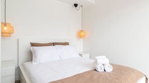 Rest in style in this minimal yet cozy bedroom with soft lighting and plush linens. #RelaxAndRecharge #DreamyNights