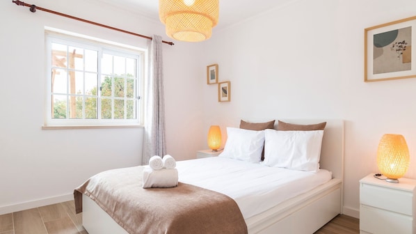 Bask in natural light and soft neutral tones for a relaxing stay in this beautifully decorated bedroom. #RelaxedLuxury #SunnyMornings