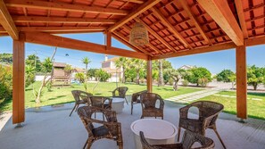 Unwind in the cool shade of this rustic pergola, perfect for al fresco conversations and lazy afternoons. #GardenRetreat #OutdoorLiving