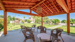 Unwind in the cool shade of this rustic pergola, perfect for al fresco conversations and lazy afternoons. #GardenRetreat #OutdoorLiving