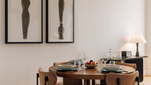 A cozy dining area with a round wooden table, elegant tableware, warm lighting, and minimalistic artwork.
#InteriorDesign
#DiningRoom
#Minimalist
#AndoLiving