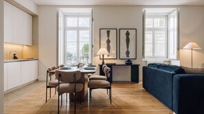 Modern dining and living space with natural light, warm wood flooring, minimalist furniture, and stylish decor. 
#InteriorDesign 
#ModernLiving 
#CozyHome 
#Minimalism
#AndoLiving