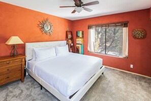 Secondary bedroom with king bed and desk for remote work.