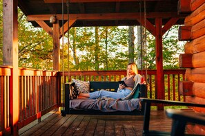 Kick your feet up on this hanging daybed and soak in the lake-front view