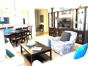 White linen sofas, swivel chair, dining area w/6 chairs, entertainment wall!