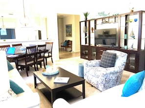 White linen sofas, swivel chair, dining area w/6 chairs, entertainment wall!