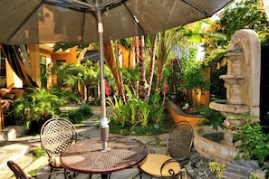 Outdoor seating with two fountains in front yard.