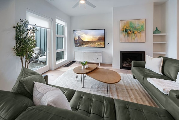Impeccably designed living room.. Plush, leather, luxurious couches, pillows and throw. .