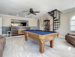 Pool table with multiple TVs and wet bar to have the perfect hangout spot when not on the boat or at the beach!
