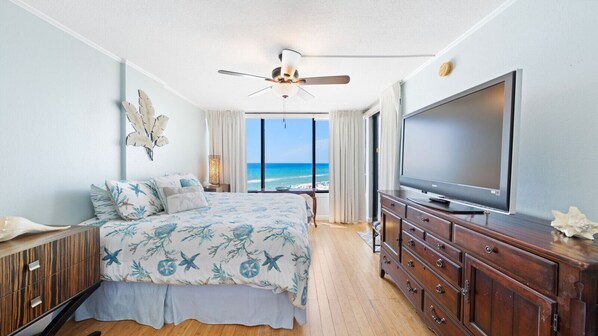 Wake up to endless ocean views in this charming beachfront bedroom featuring a cozy king bed, elegant coastal decor, and a large flat-screen TV—your personal retreat for rest and relaxation.