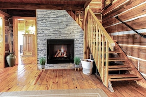 Cozy up by the rustic stone fireplace