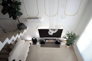 The living room is equipped with a large Sony HDTV, Apple TV, Buzz TV, Netflix SONOS audio system, a sofa bed and more 