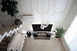 The living room is equipped with a large Sony HDTV, Apple TV, Buzz TV, Netflix SONOS audio system, a sofa bed and more