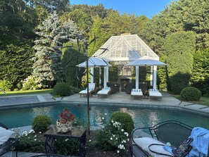 Gazebo and pool chaise lounge view