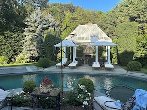 Gazebo and pool chaise lounge view