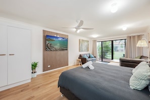 Spacious studio bedroom with ample storage and 65" smart TV