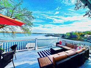 Relax in this stunning lakefront property, where a spacious deck offers breathtaking views of the water. With ample seating and a tranquil scenery, this outdoor oasis is perfect for relaxing and entertaining while enjoying the serene waterfront setting.