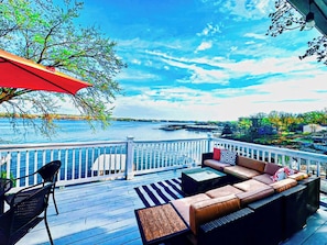 Relax in this stunning lakefront property, where a spacious deck offers breathtaking views of the water. With ample seating and a tranquil scenery, this outdoor oasis is perfect for relaxing and entertaining while enjoying the serene waterfront setting.