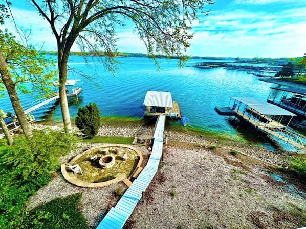 Experience the ultimate lakefront lifestyle with this property featuring direct water access, private boat docks, and a charming stone fire pit area perfect for lakeside evenings. Imagine enjoying breathtaking panoramic views of the sparkling blue waters right from your own backyard.