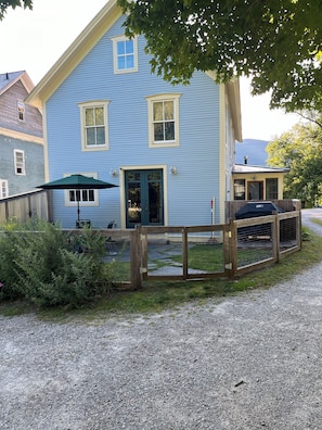 Rear entrance into kitchen off parking area via patio