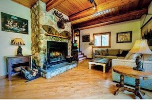 Rustic style meets refined comfort—gather around the fireplace.