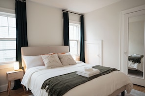 Large & spacious third bedroom with queen size bed, premium pillows, and linens.