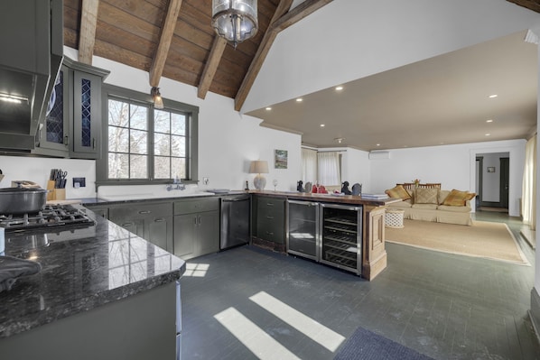 Light, well equipped eat-in kitchen opening to pool