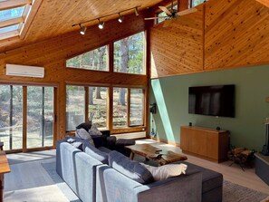 Den with pullout sofa, TV, fireplace and small dining area