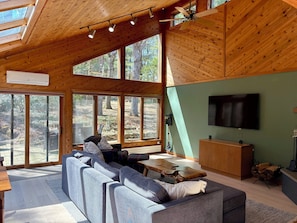 Den with pullout sofa, TV, fireplace and small dining area
