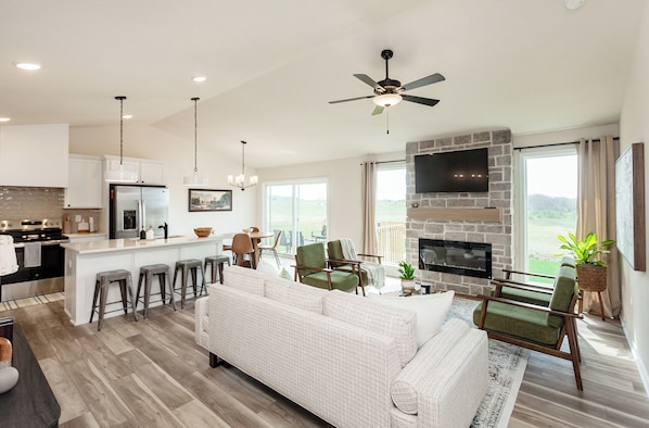 Large, vaulted, open concept living area with plenty of seating options