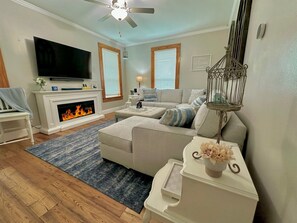 Enjoy the cozy ambiance of the electric fireplace, paired with a 65" Smart TV for your entertainment.