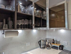 Espresso machine and kettle. Glassware for wine and liquor.