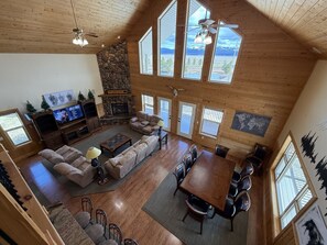 Spacious main living room with TV, gas fireplace, and dinning area