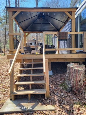 Screened in gazebo with bbq and patio furniture