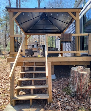 Screened in gazebo with bbq and patio furniture