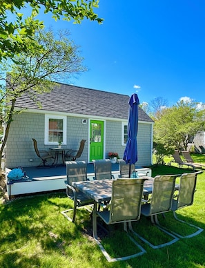 Front deck with tables, 2 chairs. Large dining table with umbrella.