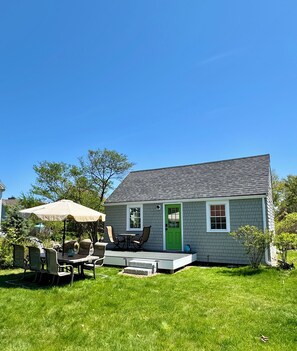 Front of cottage, front deck, large dining table off deck.