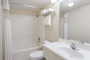 Bathroom with a shower and tub. Basic toiletries and towels are provided