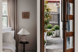 Apt 1. Bedroom detail and view from rear door