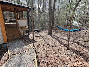 Hammock, charcoal grill and entry to cabin